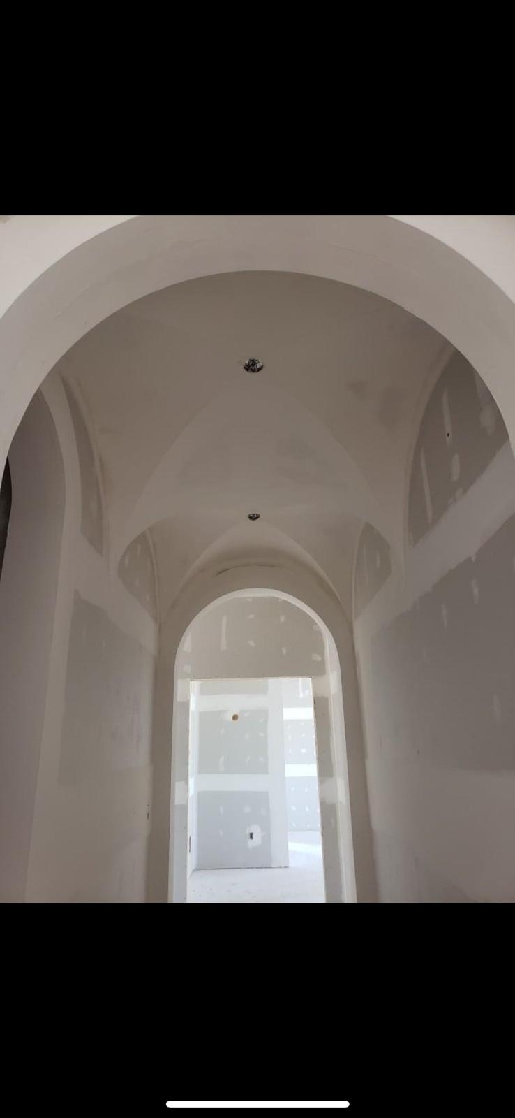 Arched hallway and vaulted ceiling